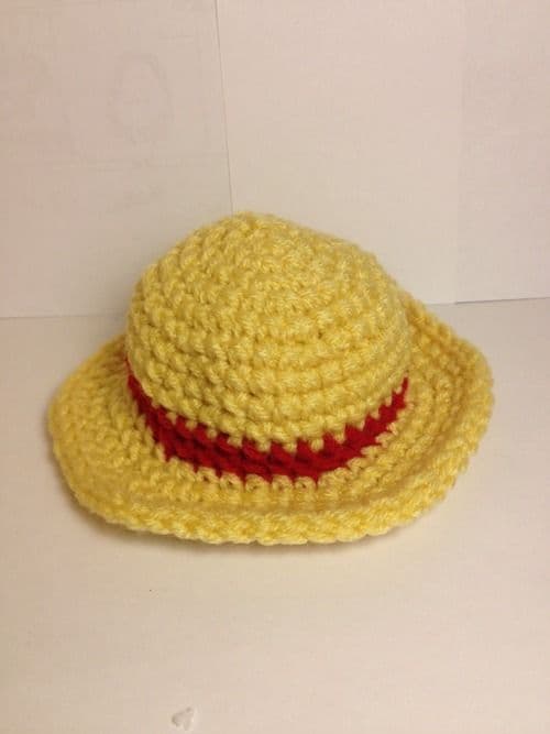 Crocheted straw hat with a red band